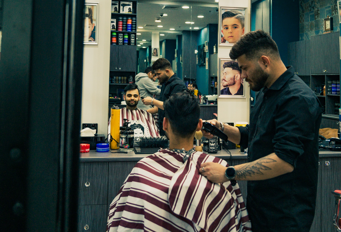 A customer in the chair with one of our experienced and skilled barbers